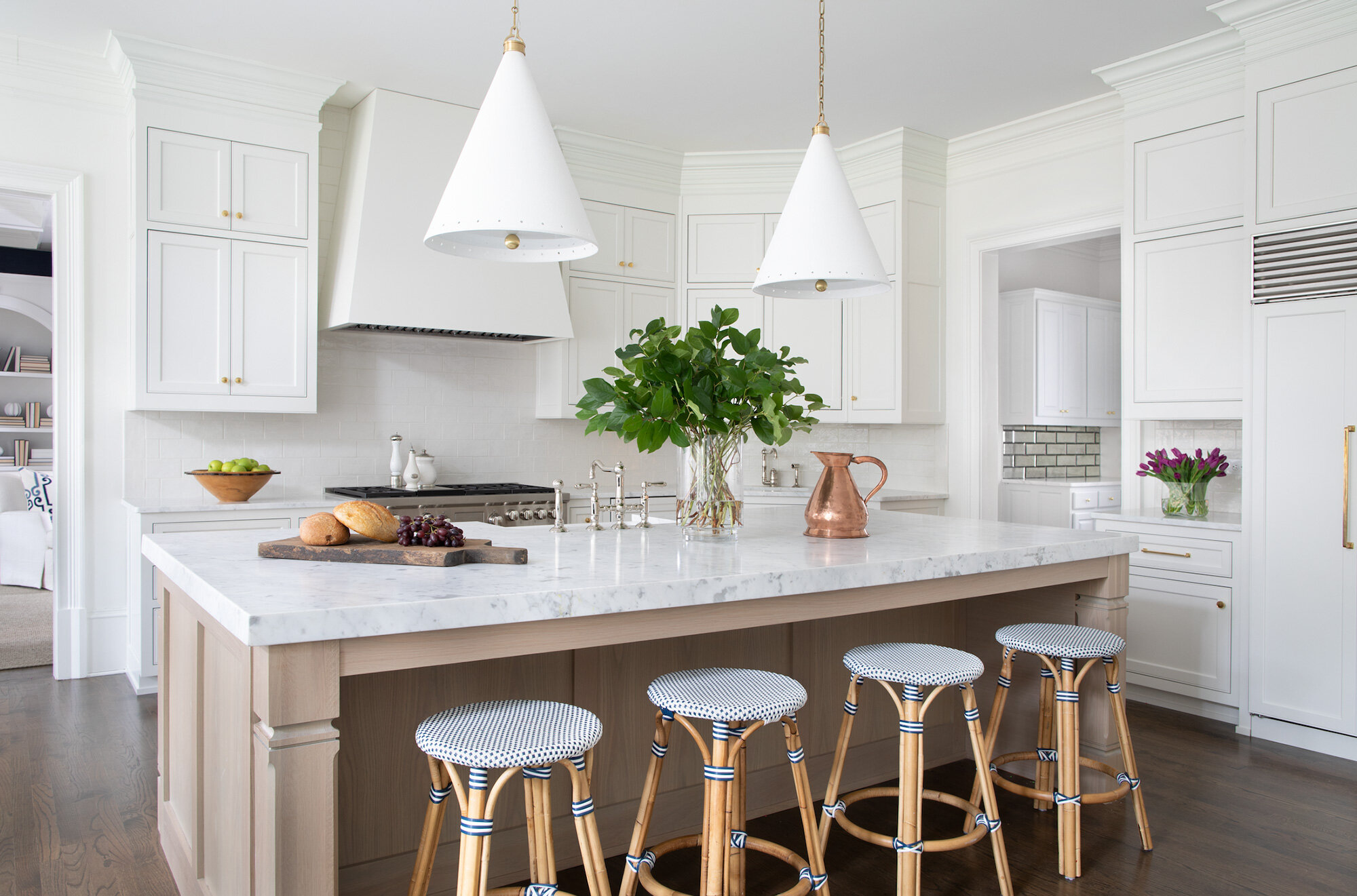 Bathroom vanity remodel with marble counters and white cabinets